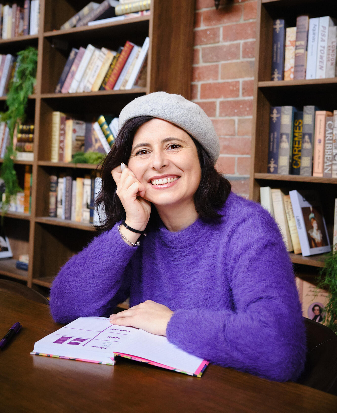 designer's profile in a library smiling